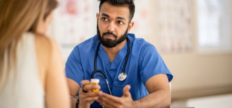 Patient sitting across from her doctor as they discuss her medications